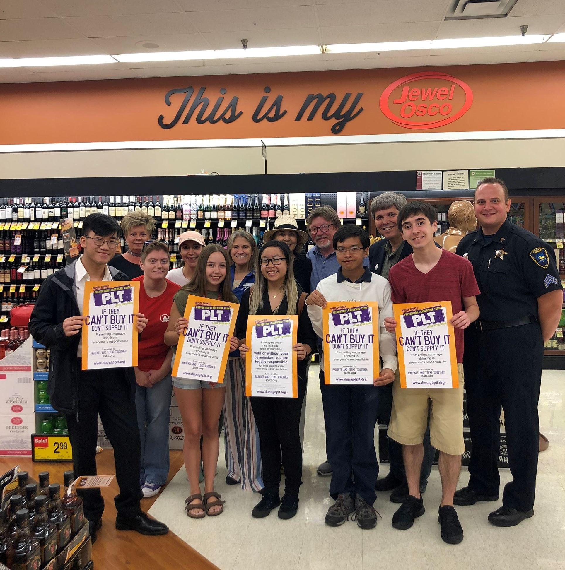 Adult and youth coalition members participating in a local sticker shock campaign.